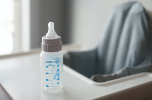 Baby bottle sitting on table